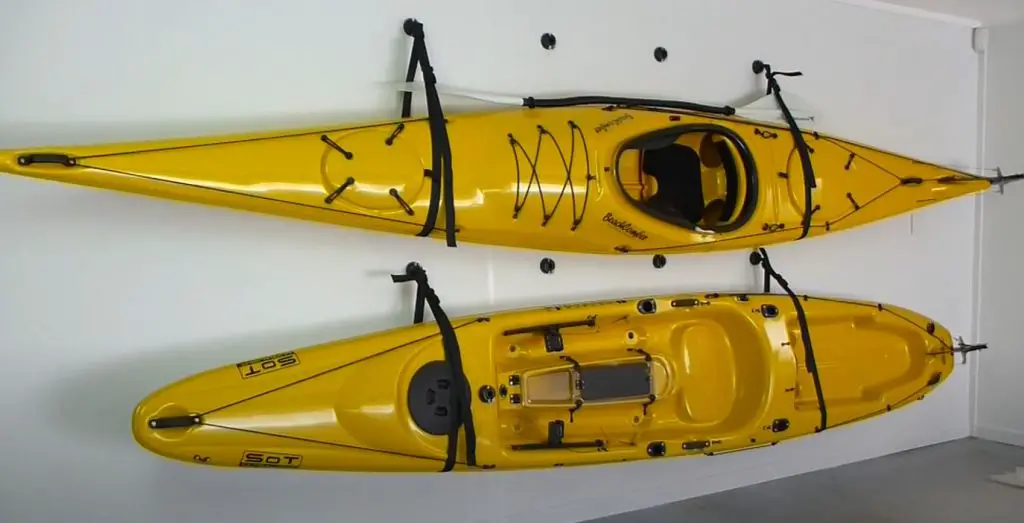 Example of how to store a kayak in an apartment by hanging it on the wall