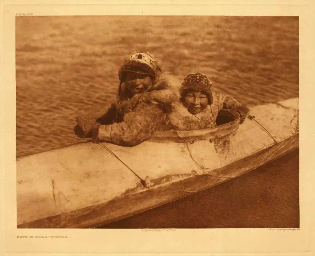 Two people in kayak, Nunivak, Alaska, photographed by Edward S. Curtis, 1930.