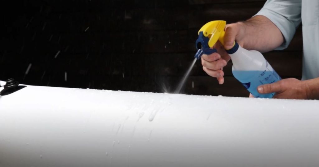 Use soapy water to find and fix a leak in an inflatable kayak.